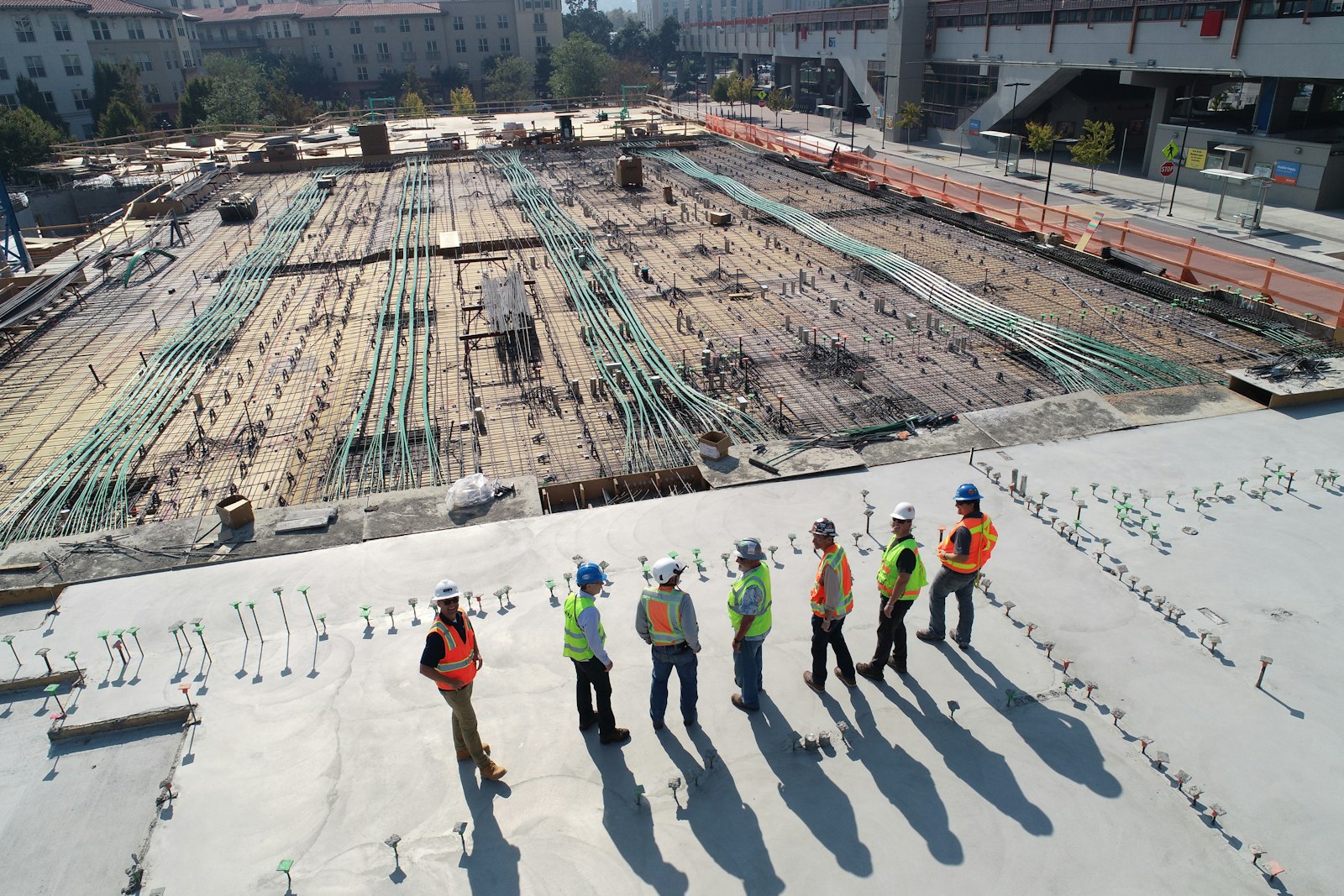 Owner's representative and project team reviewing a concrete deck together during a milestone site walk