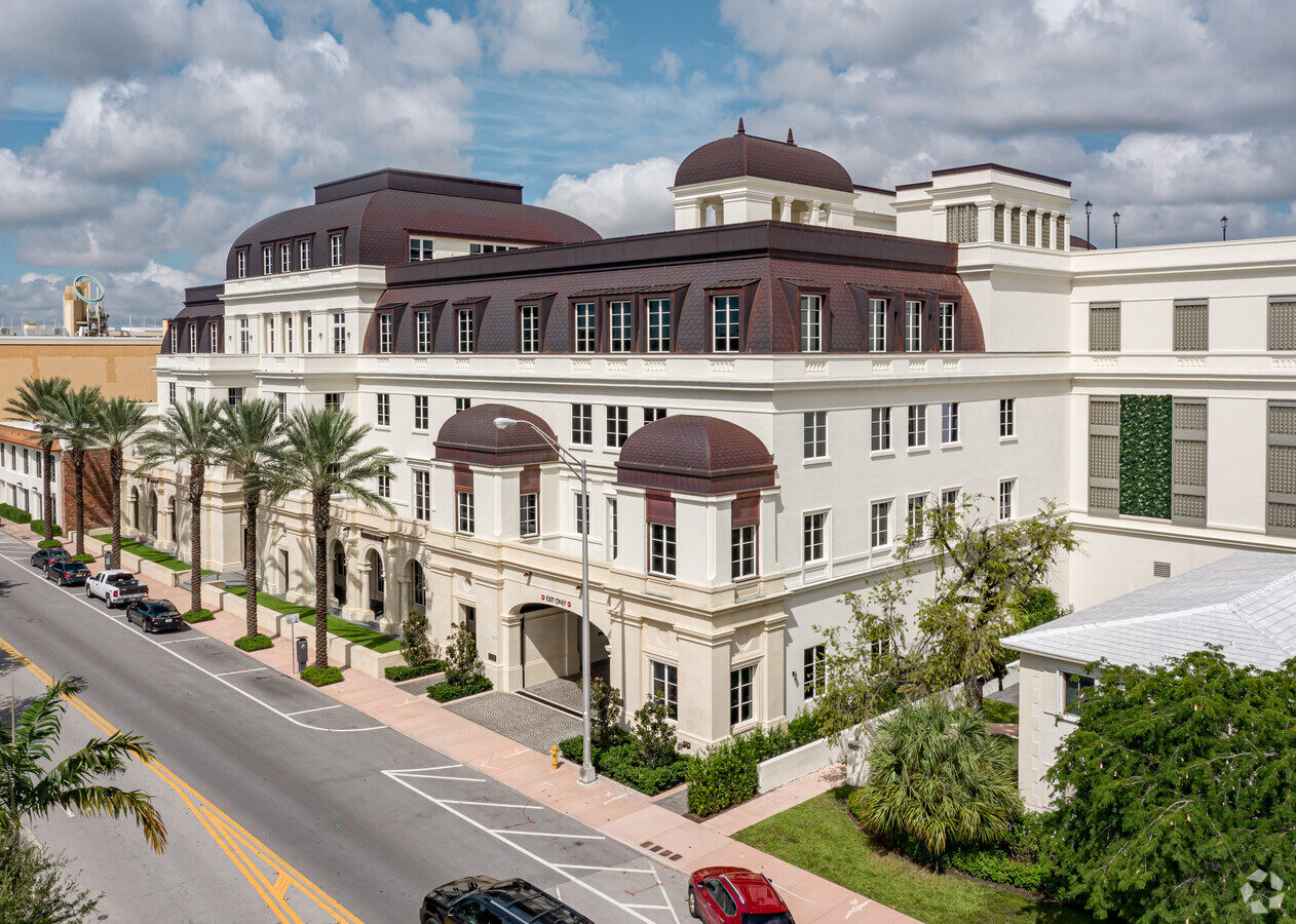 1515 Sunset Offices Mediterranean revival office building lined with palm trees in Coral Gables