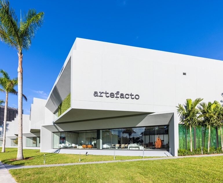Artefacto Showroom white modern building exterior framed by palm trees